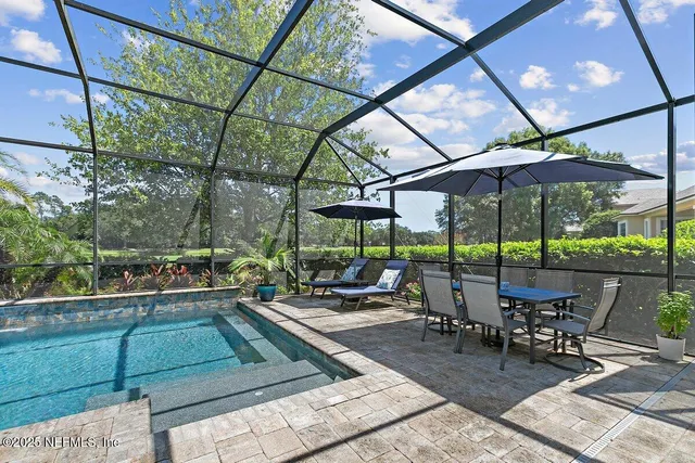 a view of a patio with a table and chairs under an umbrella