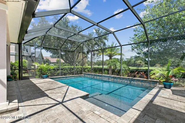 a view of backyard with a patio and plants