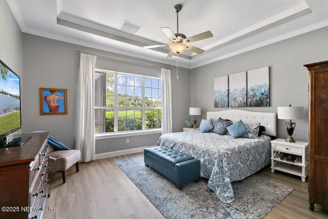 a bedroom with a bed and a chandelier