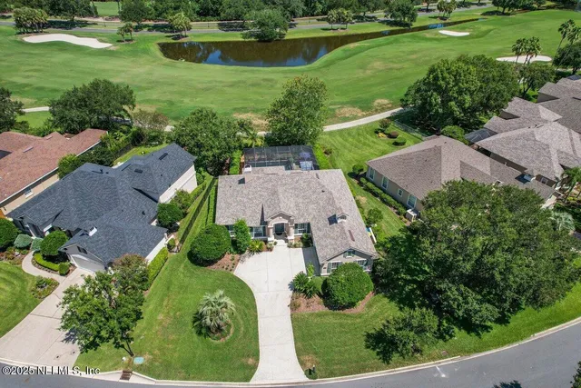 an aerial view of a house with a yard