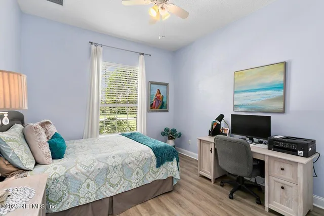 a bedroom with a bed and a desk