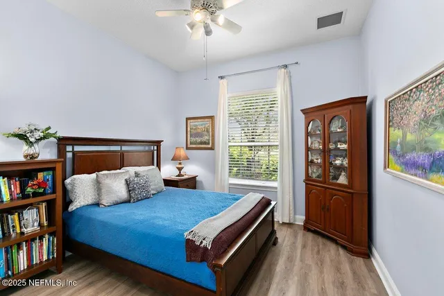 a bedroom with a bed and a book shelf