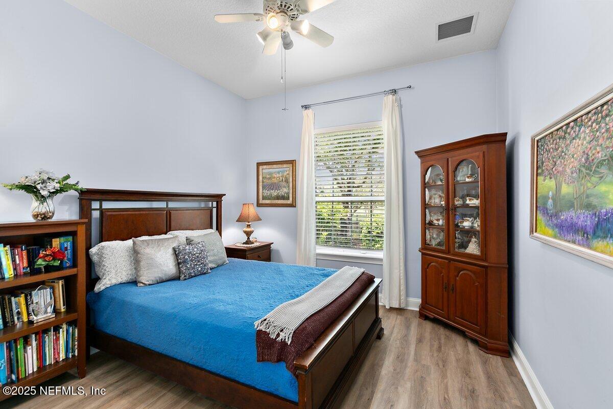 417 Blagdon Court Jacksonville, FL 32225 - Photo 26 of 43 a bedroom with a bed and a book shelf