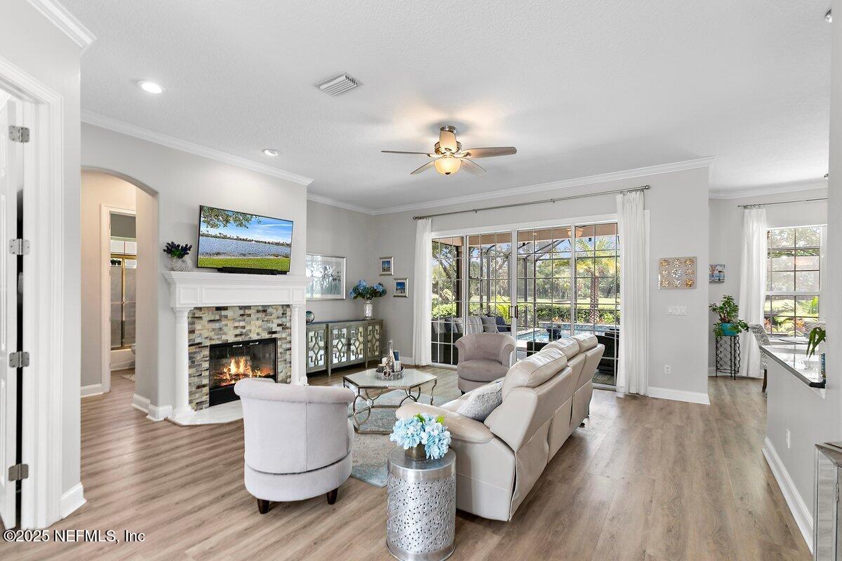 417 Blagdon Court Jacksonville, FL 32225 - Photo 6 of 43 a living room with fireplace furniture and a wooden floor