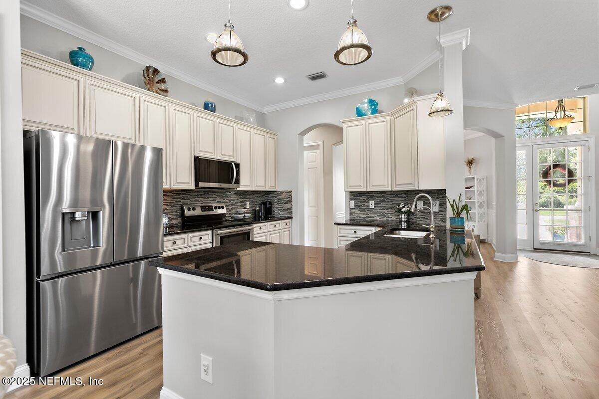 417 Blagdon Court Jacksonville, FL 32225 - Photo 10 of 43 a kitchen with stainless steel appliances granite countertop a refrigerator a stove top oven a sink and dishwasher