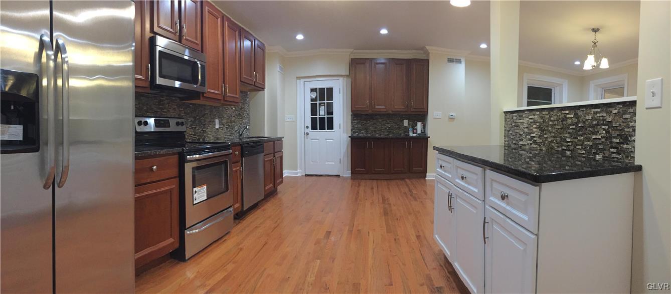 4447 Shankweiler Road Orefield, PA 18069 - Photo 3 of 11 a kitchen with stainless steel appliances granite countertop a stove a sink and a refrigerator
