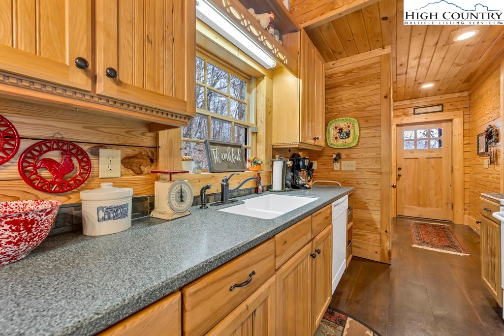 3043 Junaluska Road Boone, NC 28607 - Photo 12 of 49 a kitchen with granite countertop a sink a stove and cabinets