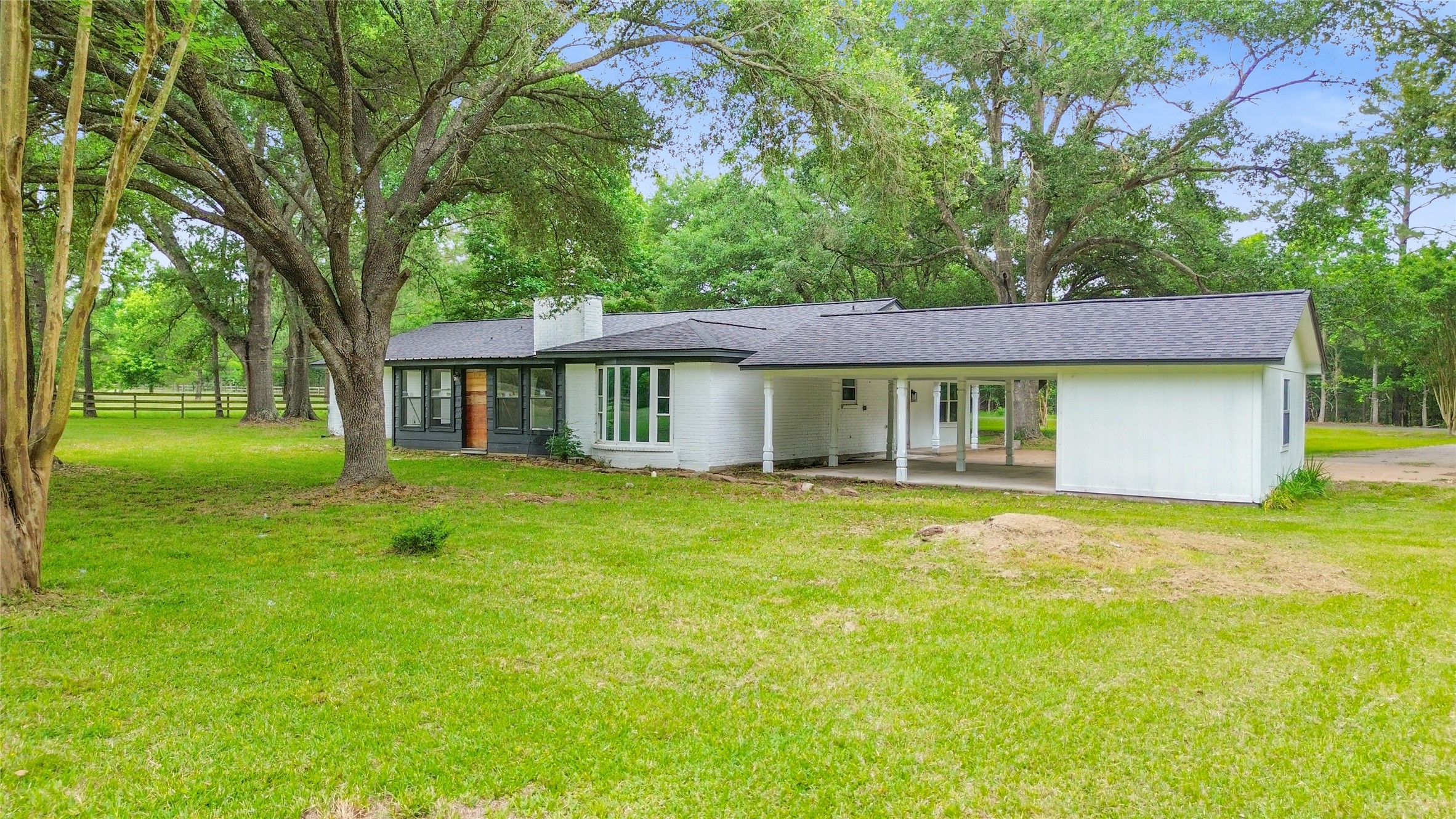 74 Robinson Road Huntsville, TX 77320 - Photo 25 of 33 a view of a house with a yard