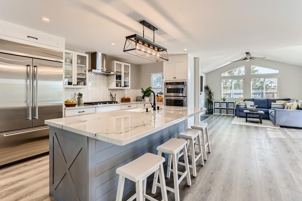 a large kitchen with a table and chairs