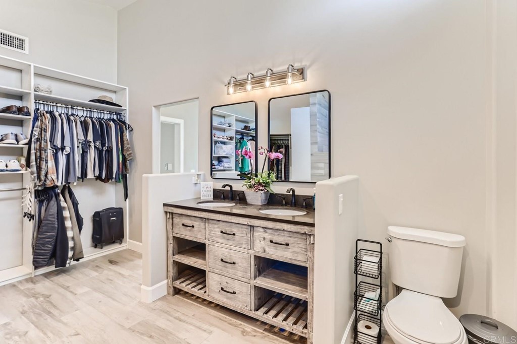2015 Shadow Grove Way Encinitas, CA 92024 - Photo 16 of 28 a bathroom with a toilet a sink and a mirror