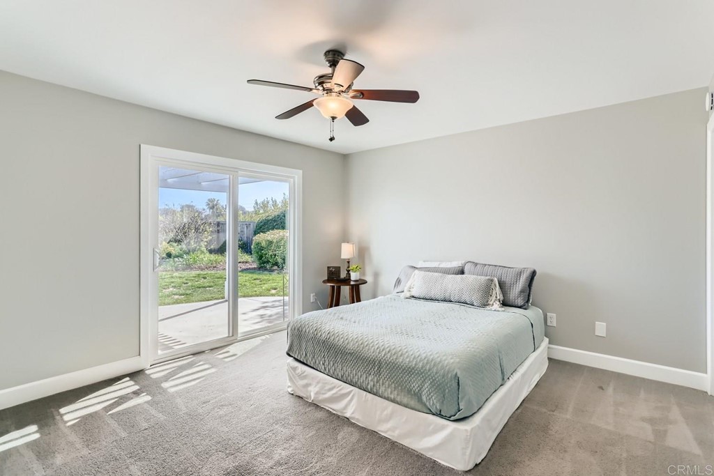 2015 Shadow Grove Way Encinitas, CA 92024 - Photo 18 of 28 a bedroom with a large bed and a chandelier