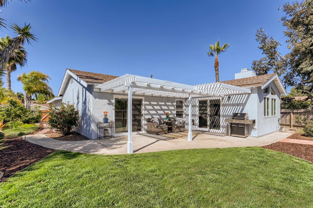 2015 Shadow Grove Way Encinitas, CA 92024 - Photo 27 of 28 a view of a house with a yard patio and fire pit