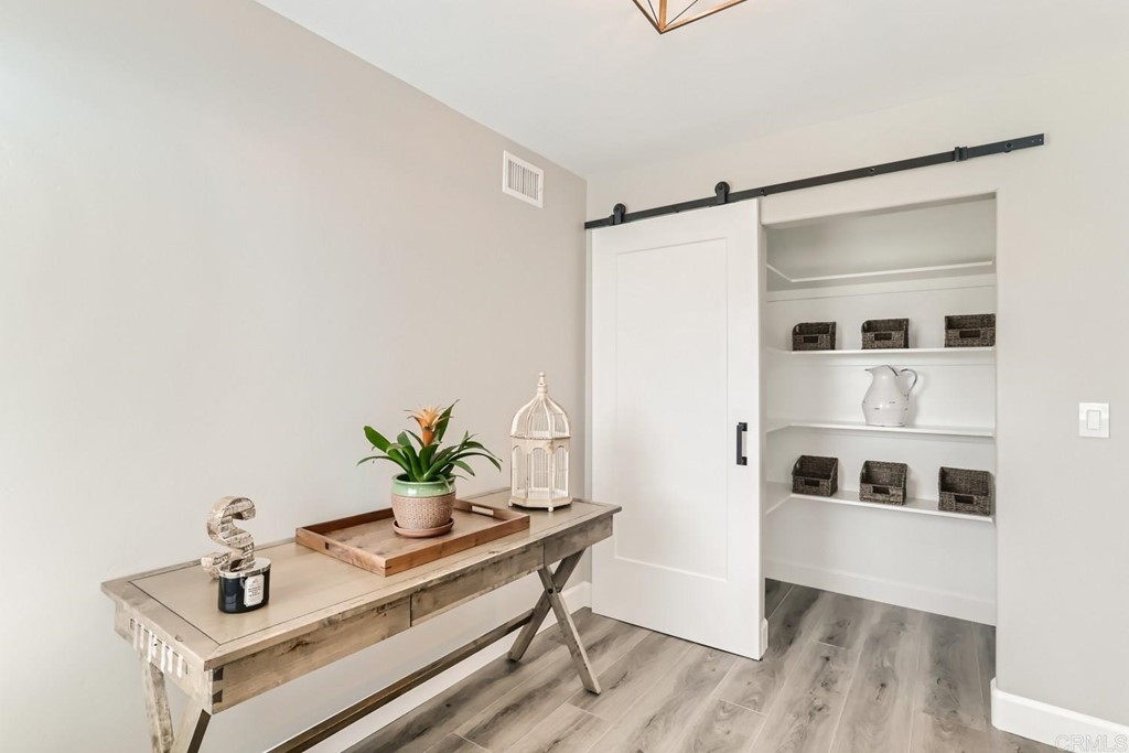 2015 Shadow Grove Way Encinitas, CA 92024 - Photo 7 of 28 a white room with wooden floor and potted plant