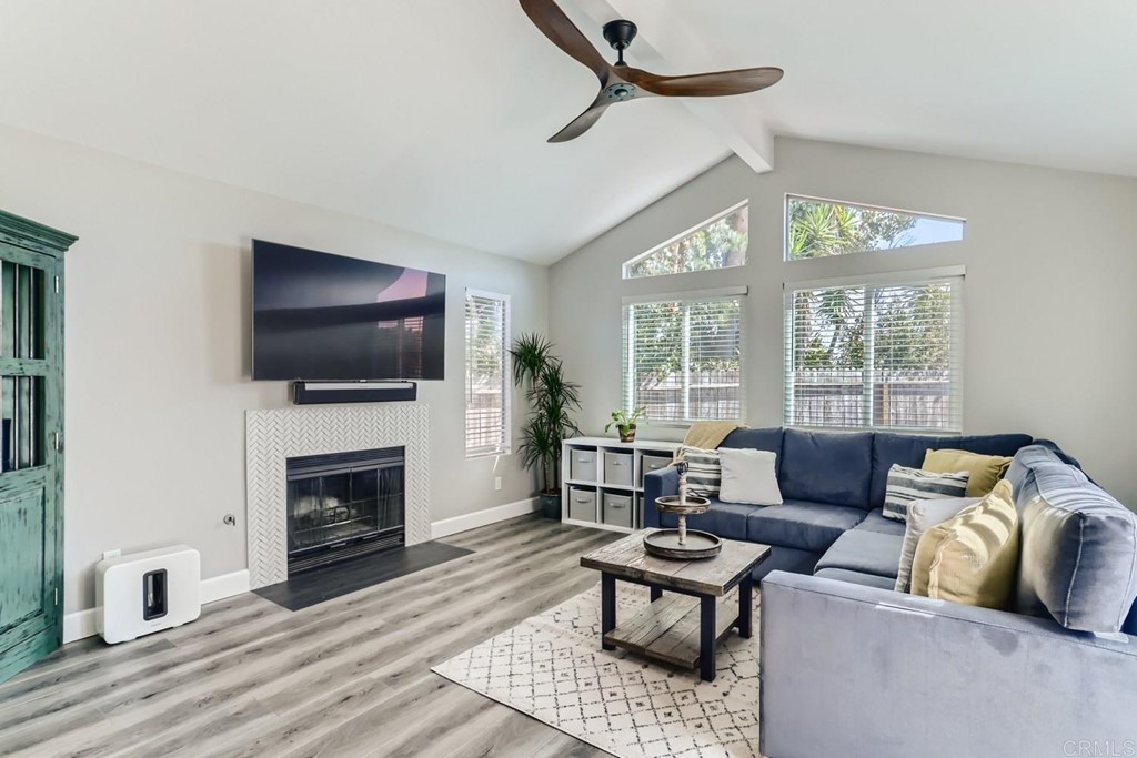 2015 Shadow Grove Way Encinitas, CA 92024 - Photo 9 of 28 a living room with furniture a flat screen tv and a fireplace