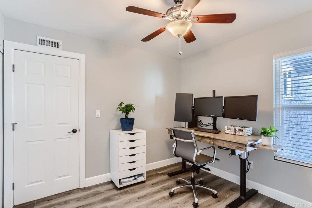 2015 Shadow Grove Way Encinitas, CA 92024 - Photo 10 of 28 a view of a workspace with furniture and wooden floor
