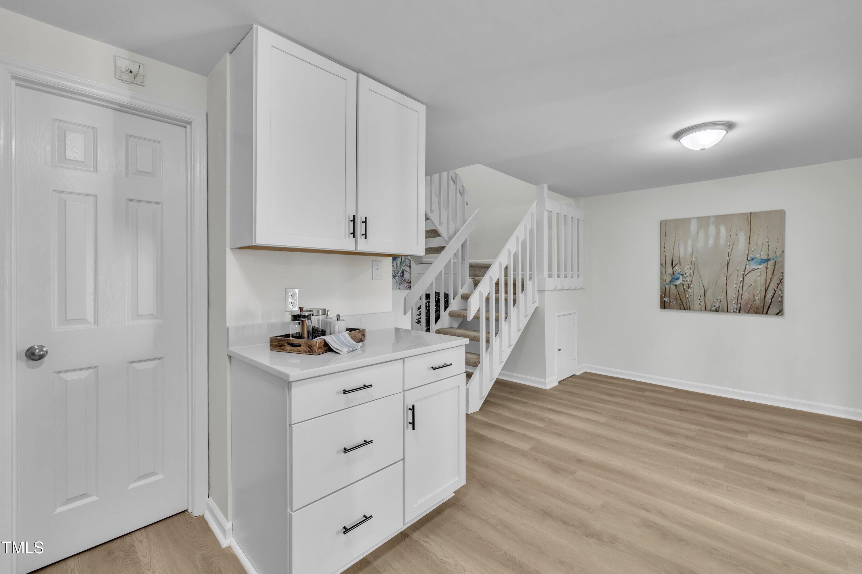 632 Middleton Avenue Cary, NC 27513 - Photo 20 of 34 a kitchen with white cabinets and wooden floor