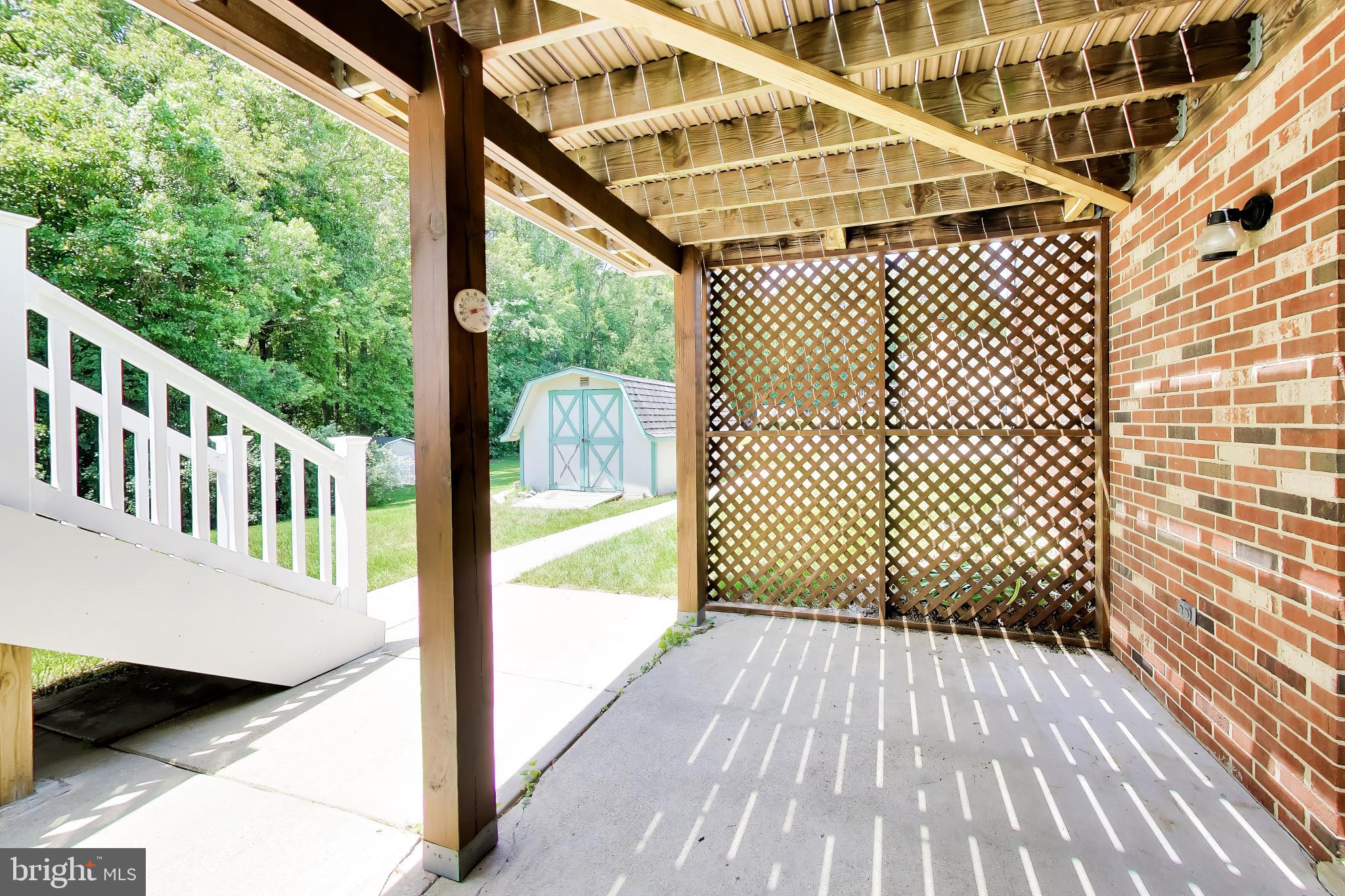 30075 Huntt Road Mechanicsville, MD 20659 - Photo 40 of 45 Patio with sidewalk to stairs & shed