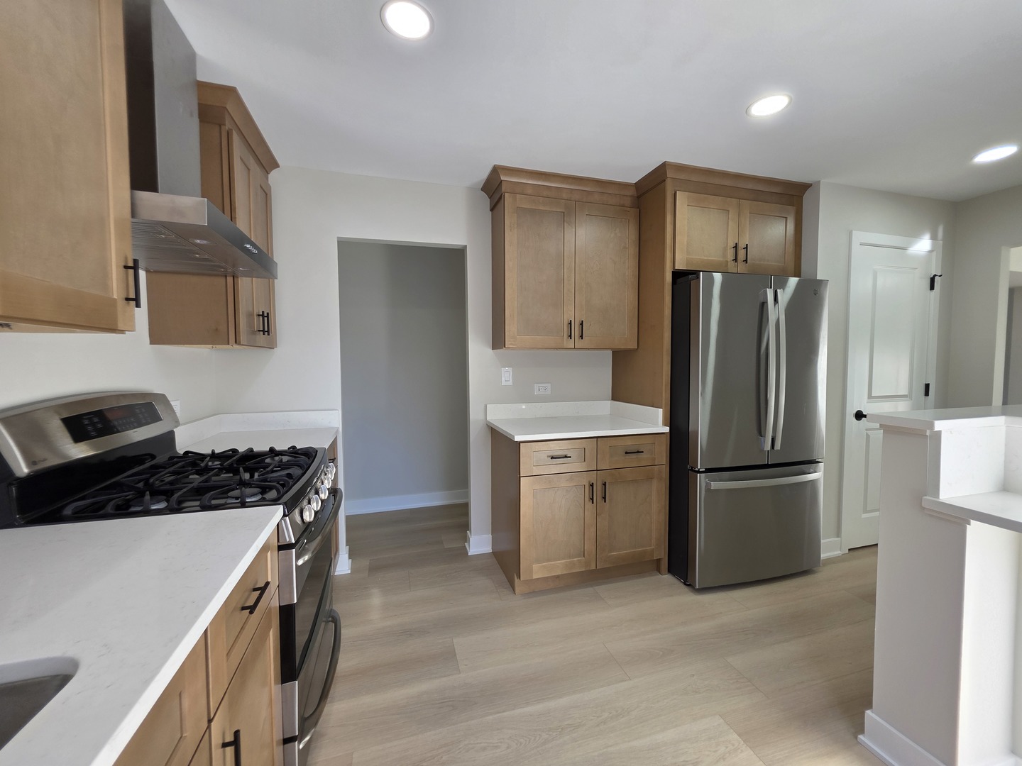 2187 Walnut Avenue Hanover Park, IL 60133 - Photo 11 of 38 a kitchen with a refrigerator and a stove top oven