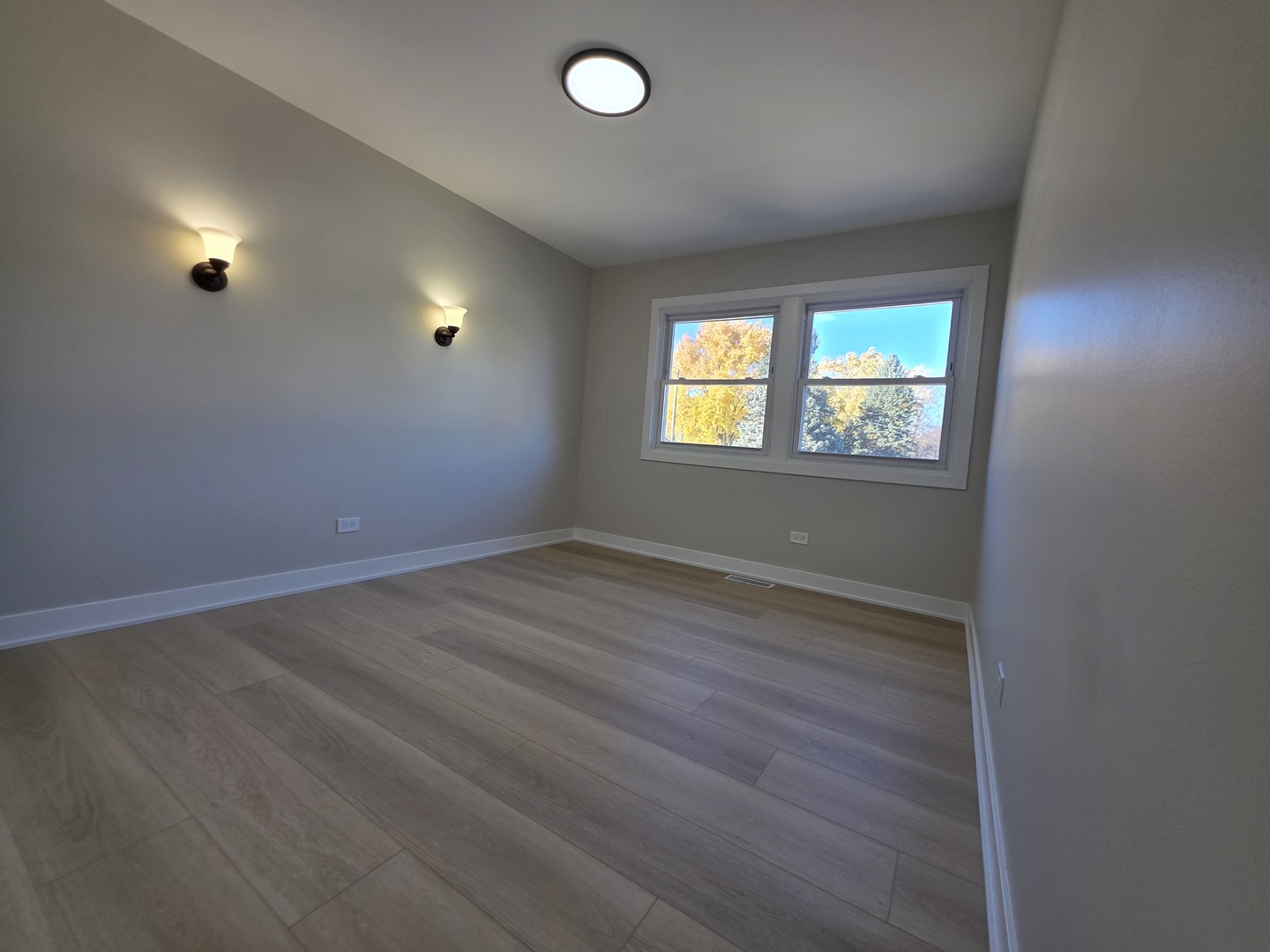 2187 Walnut Avenue Hanover Park, IL 60133 - Photo 20 of 38 an empty room with wooden floor and windows