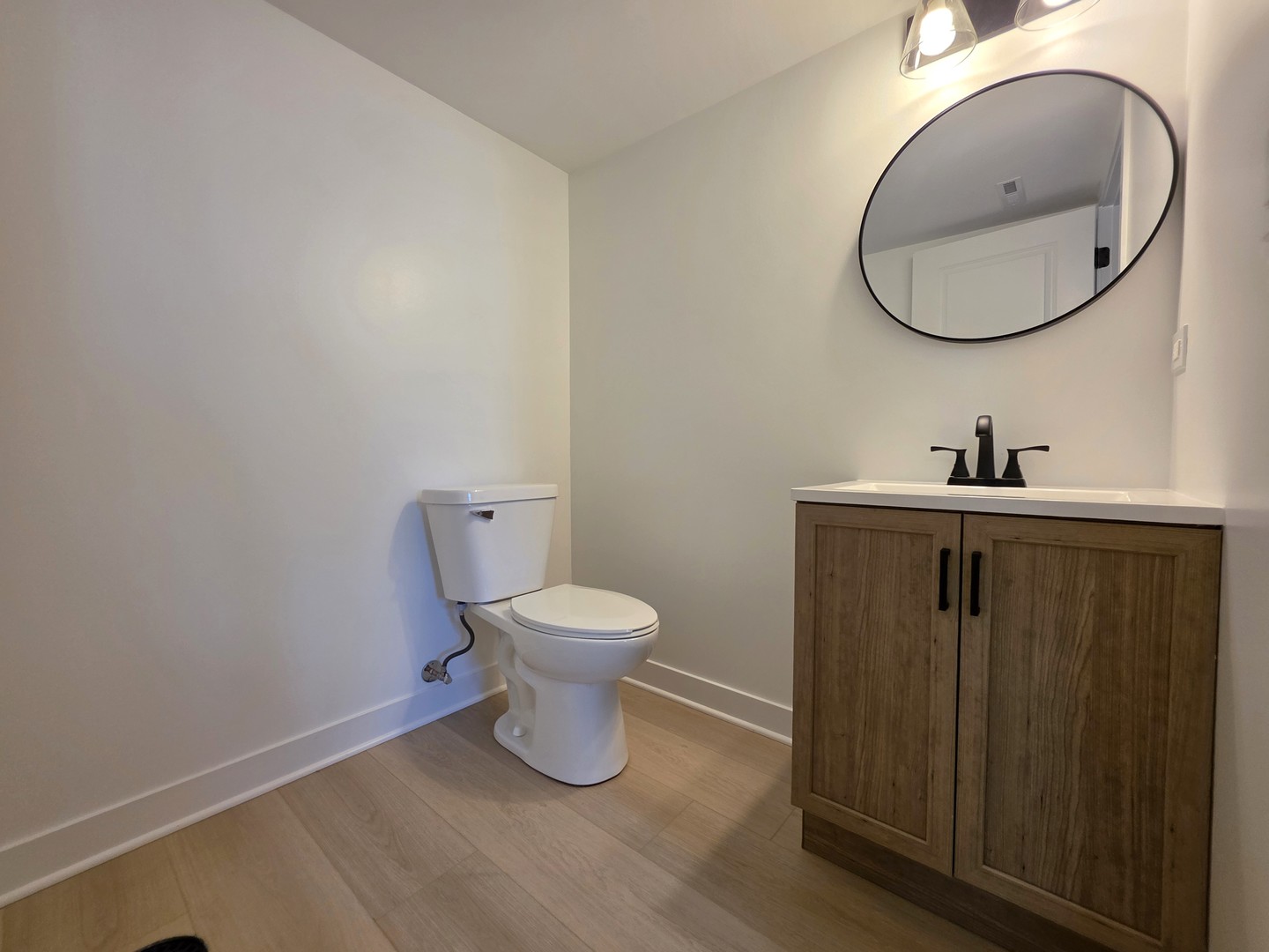 2187 Walnut Avenue Hanover Park, IL 60133 - Photo 29 of 38 a bathroom with a toilet sink and mirror