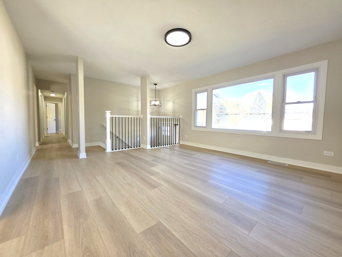 2187 Walnut Avenue Hanover Park, IL 60133 - Photo 5 of 38 an empty room with wooden floor and windows
