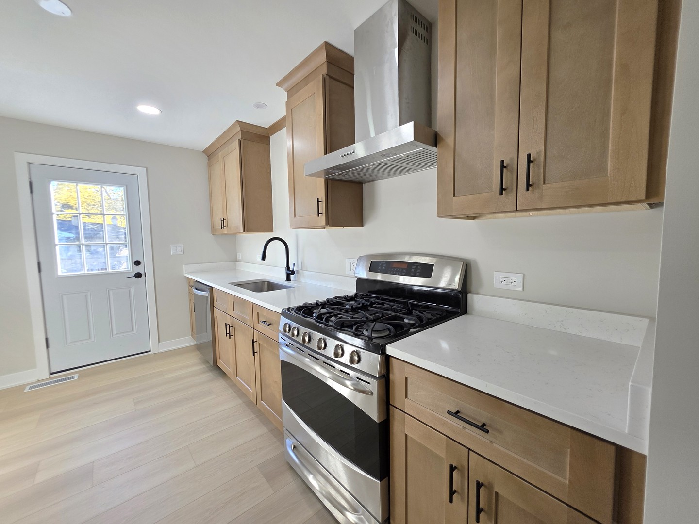 2187 Walnut Avenue Hanover Park, IL 60133 - Photo 8 of 38 a kitchen with stainless steel appliances a stove a sink and cabinets