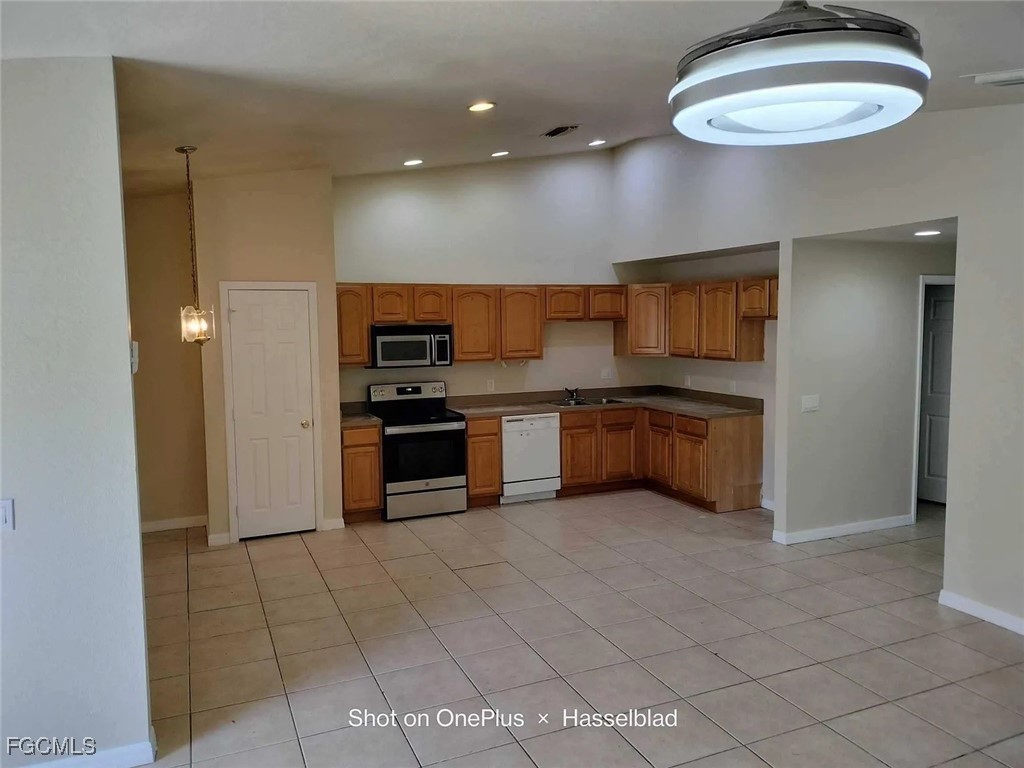 531 Alabama Road South Lehigh Acres, FL 33974 - Photo 2 of 2 a kitchen with stainless steel appliances granite countertop a sink and cabinets