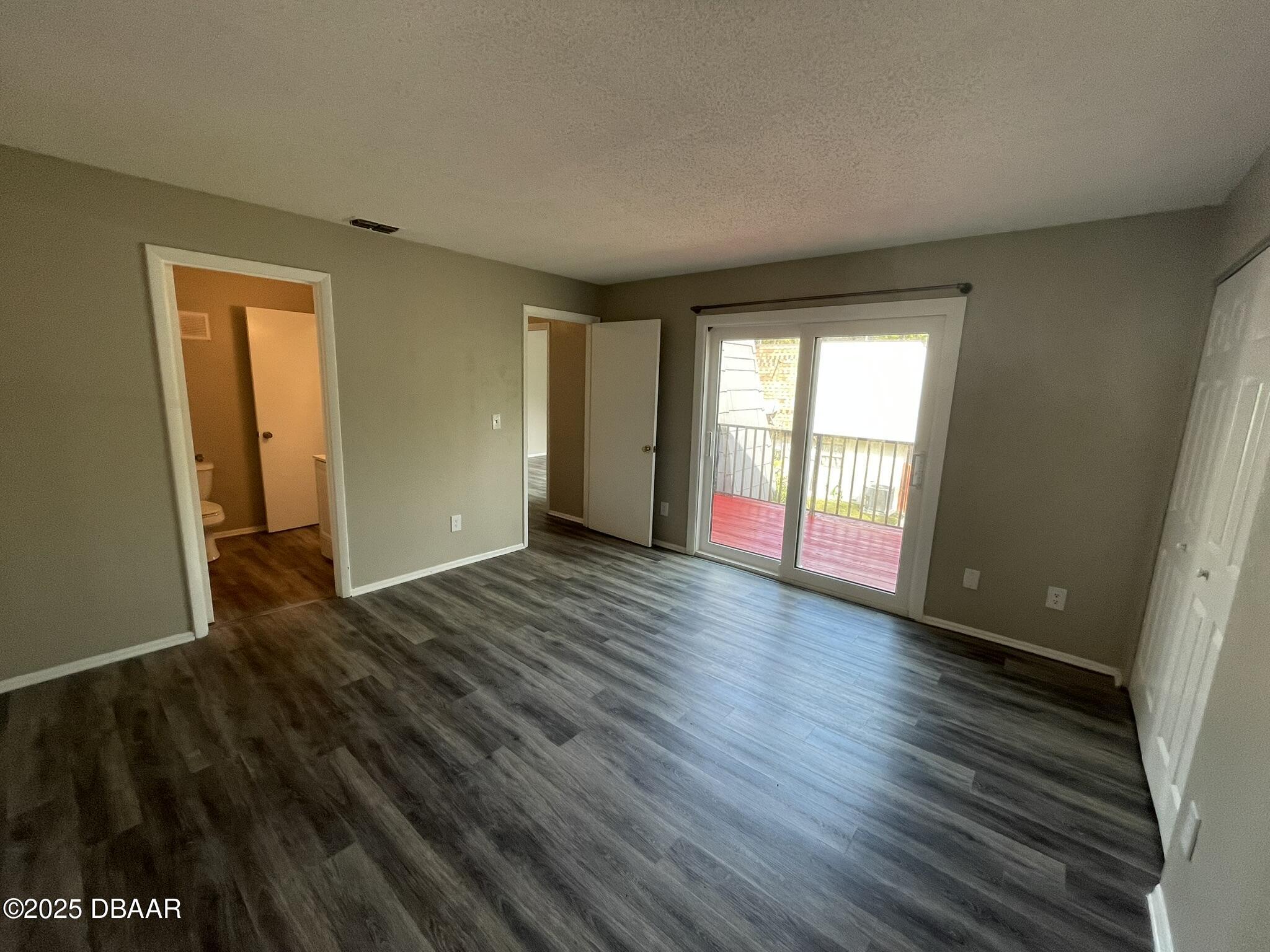 97 Springwood Square Port Orange, FL 32129 - Photo 17 of 23 a view of an empty room with wooden floor and a window