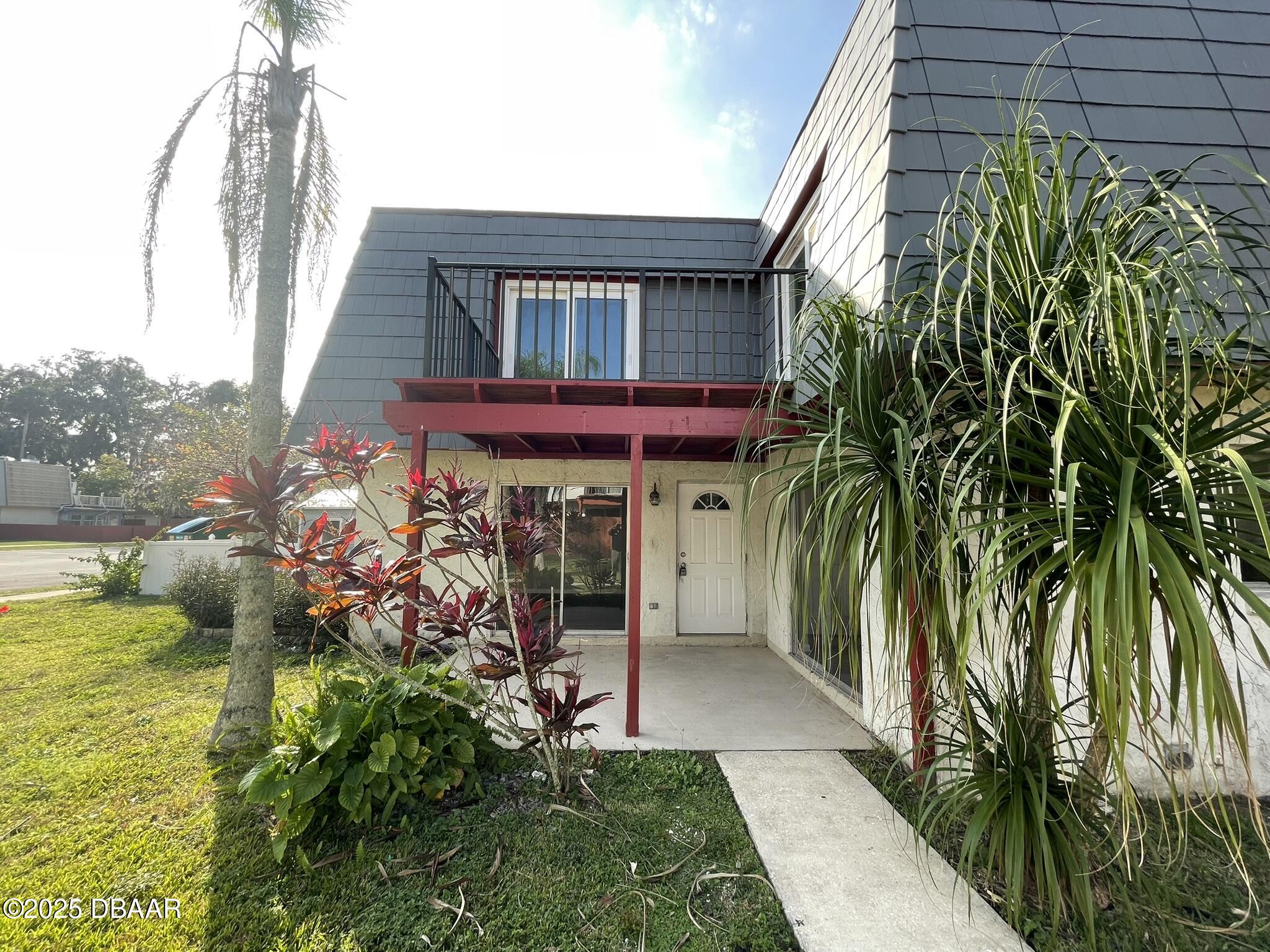 97 Springwood Square Port Orange, FL 32129 - Photo 2 of 23 a view of a house with a porch
