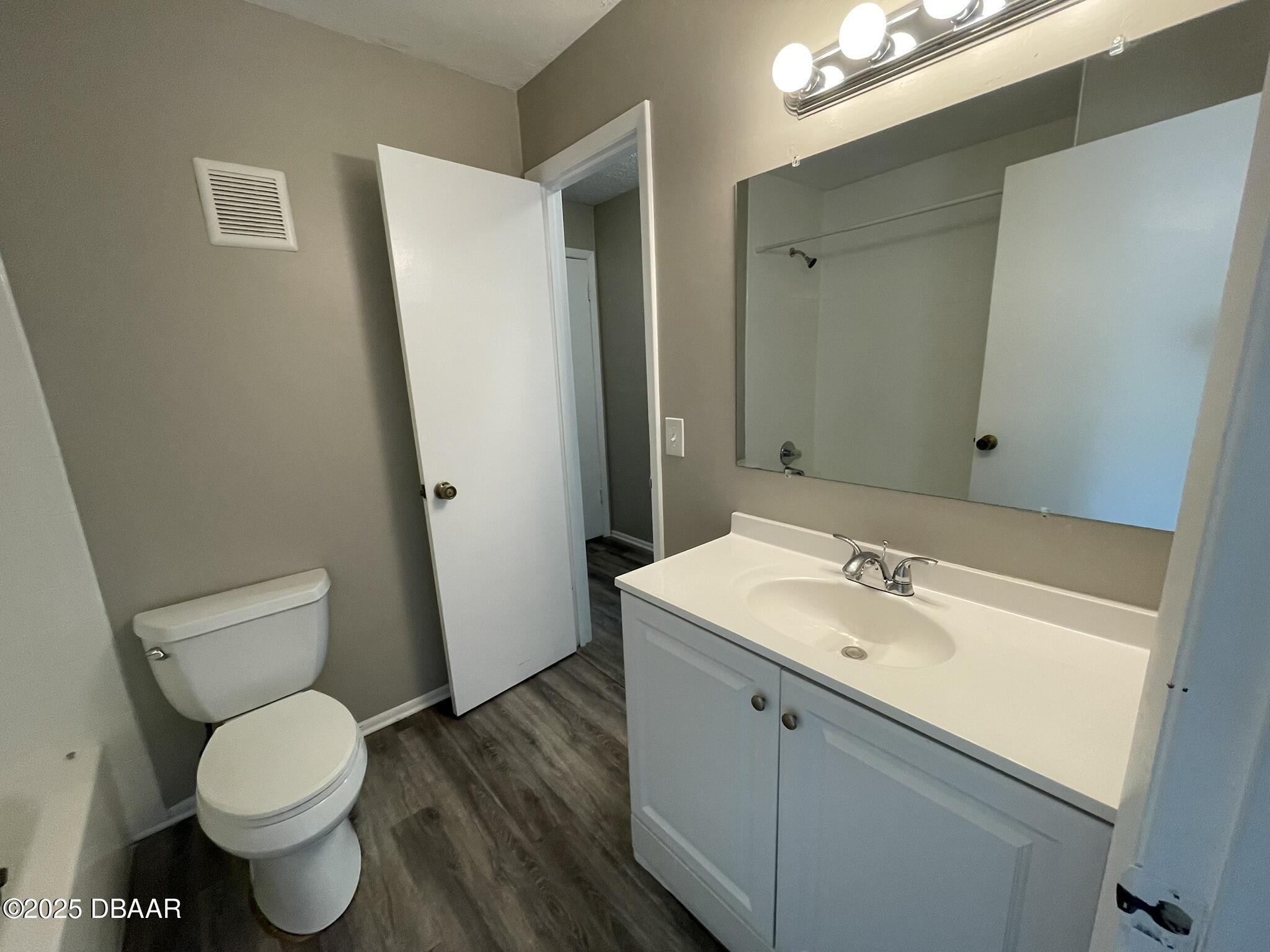 97 Springwood Square Port Orange, FL 32129 - Photo 23 of 23 a bathroom with a toilet sink and mirror