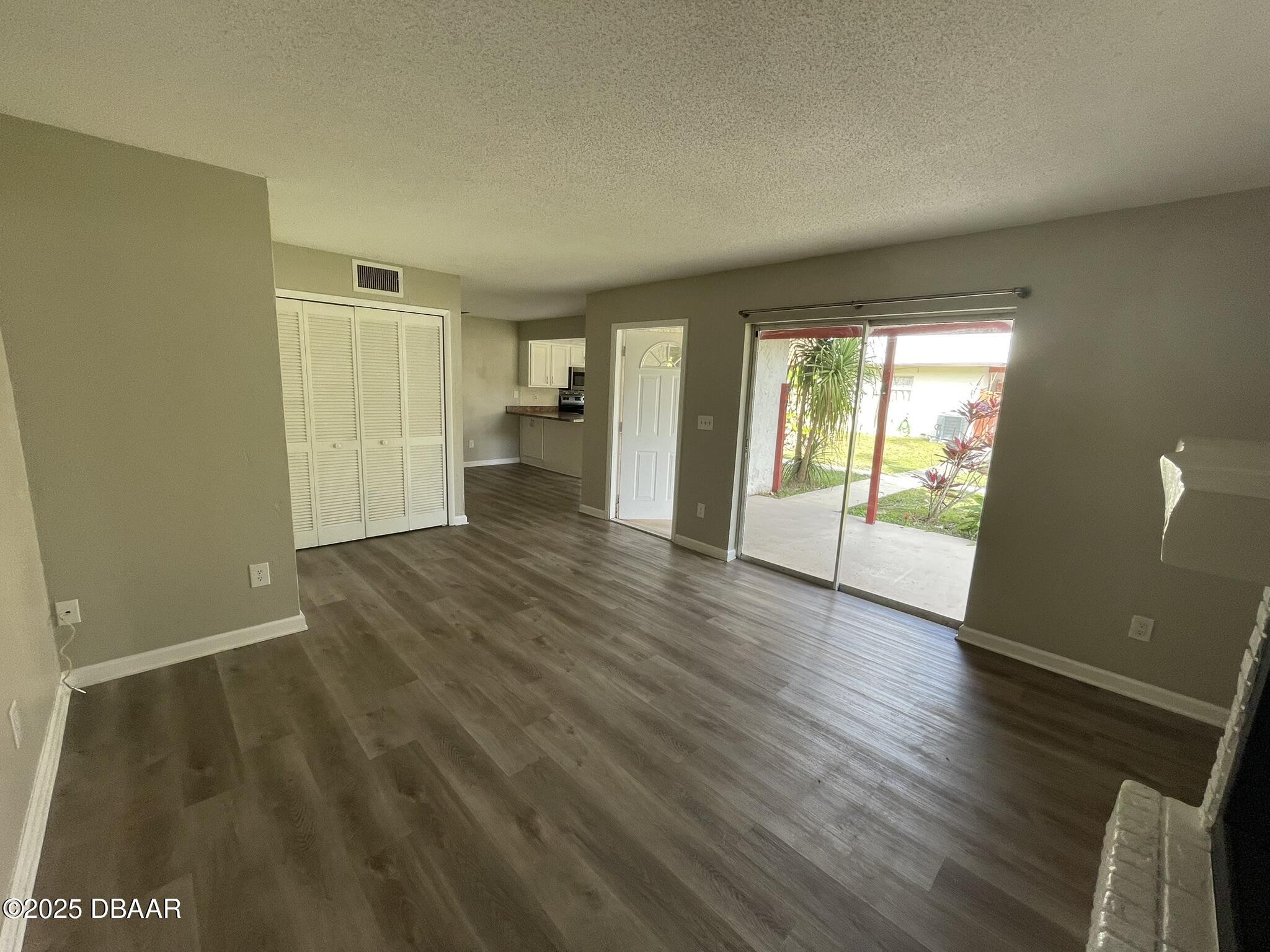 97 Springwood Square Port Orange, FL 32129 - Photo 6 of 23 an empty room with wooden floor and windows