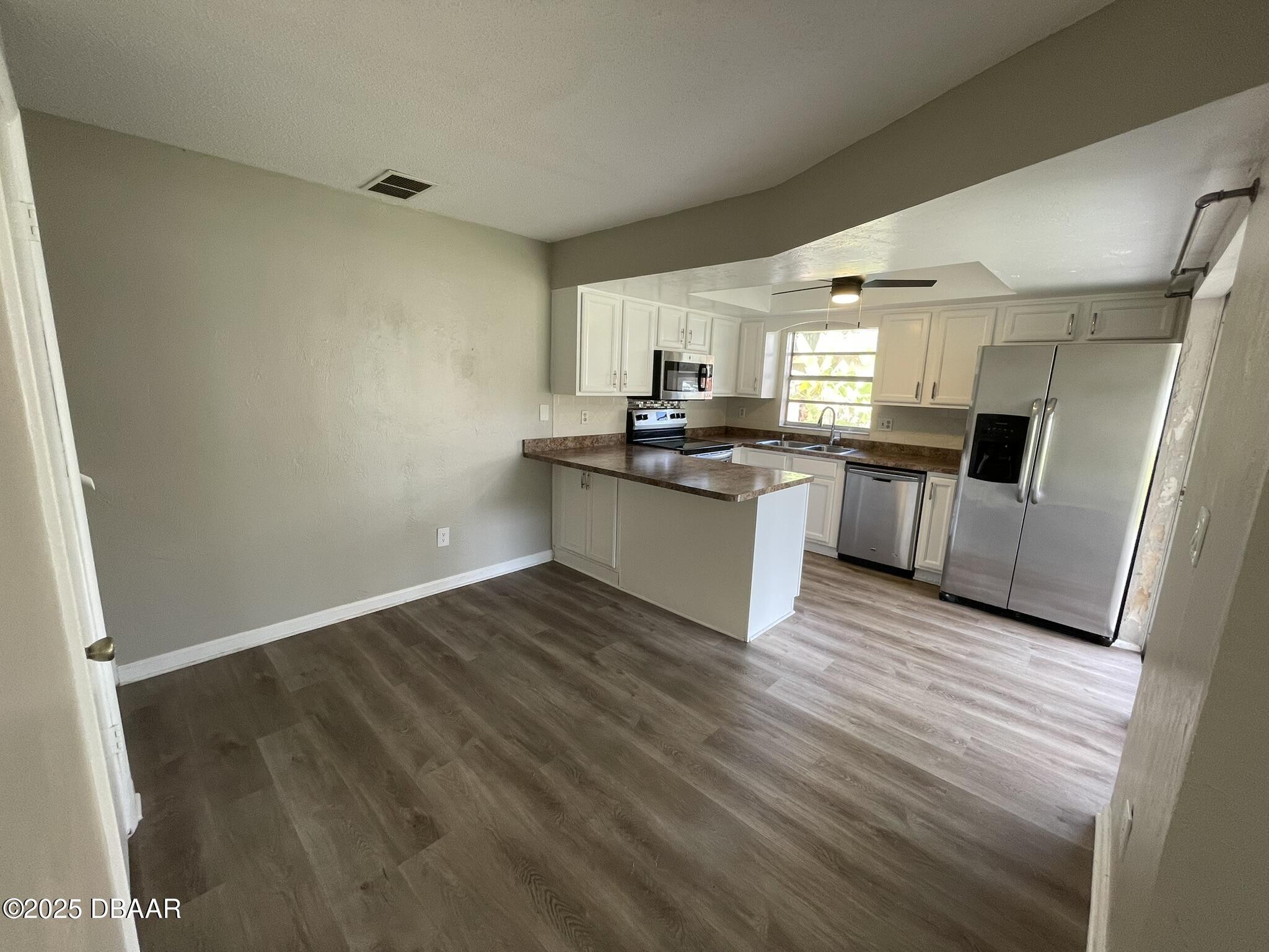 97 Springwood Square Port Orange, FL 32129 - Photo 7 of 23 a kitchen with granite countertop a sink cabinets and stainless steel appliances