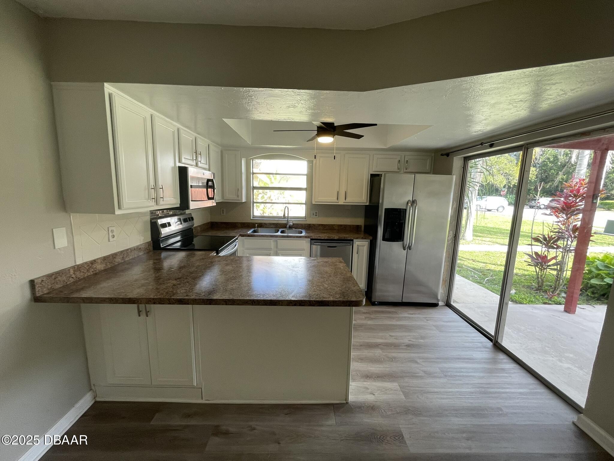 97 Springwood Square Port Orange, FL 32129 - Photo 8 of 23 a kitchen with kitchen island granite countertop a sink and a counter top space