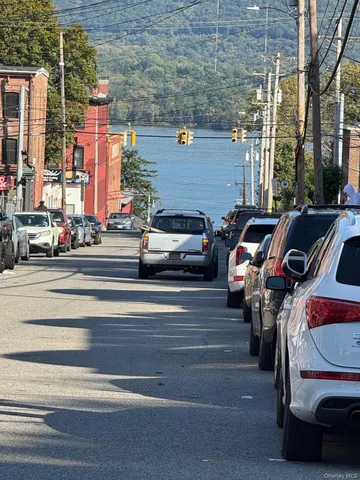 a view of a cars park on the street