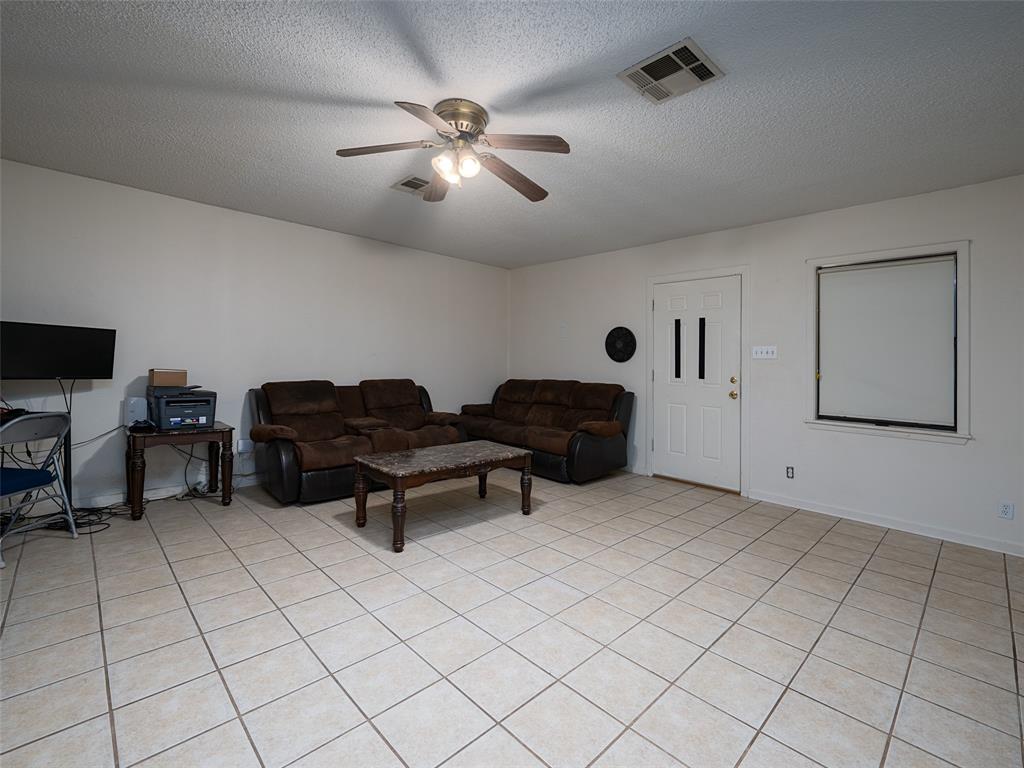 9663 Matise Street Tyler, TX 75706 - Photo 14 of 15 a living room with furniture and a chandelier