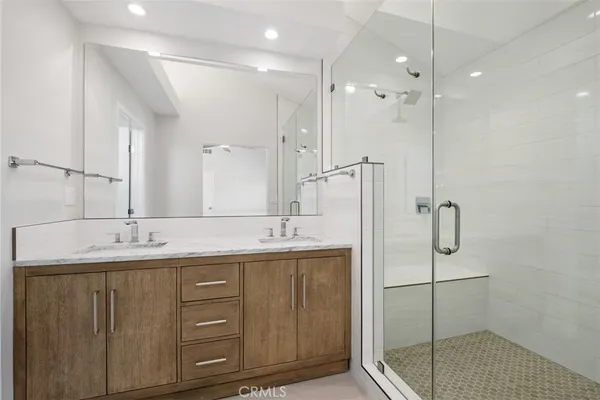 a bathroom with a double vanity sink mirror and double