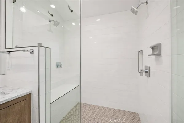 a bathroom with a shower and a glass door