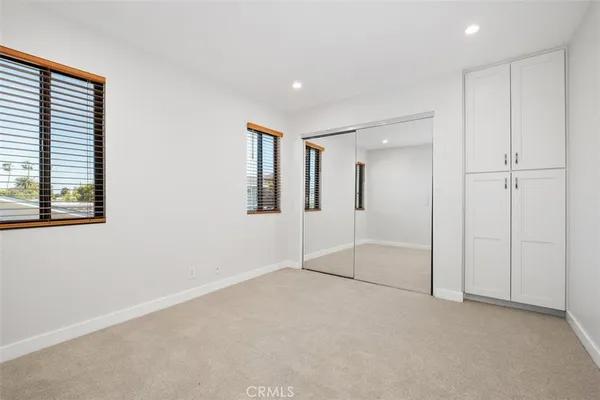 an empty room with a empty space and windows