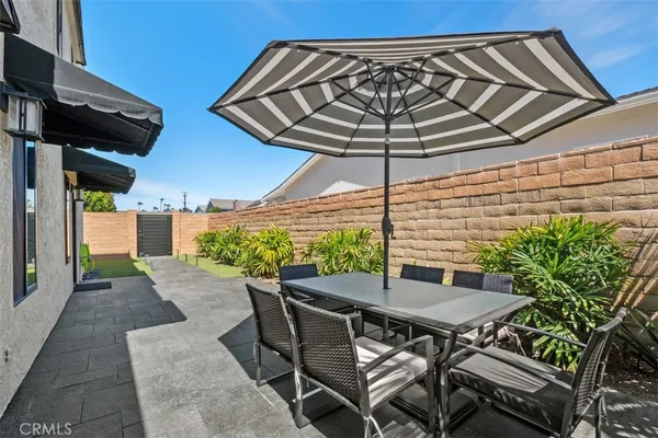 a patio with a table and chairs