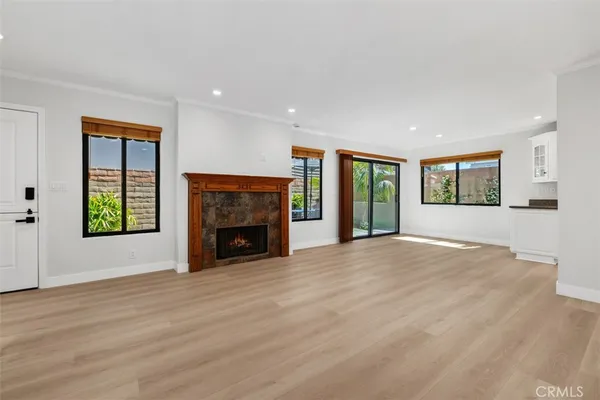 a view of a livingroom with a fireplace and window