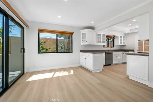 a large kitchen with stainless steel appliances granite countertop a stove and a sink