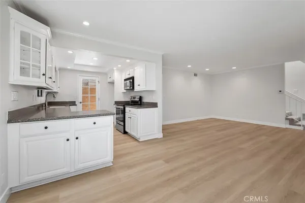 a large kitchen with kitchen island a sink stainless steel appliances and cabinets