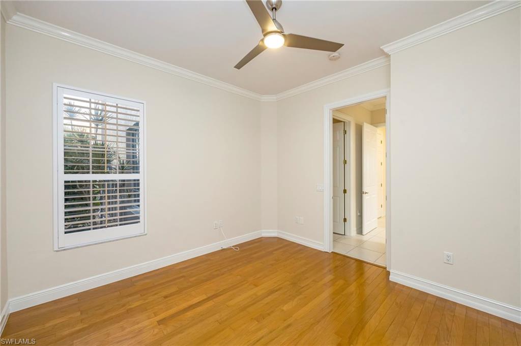 5025 Maxwell Circle, Unit 2 Naples, FL 34105 - Photo 14 of 24 a view of empty room with wooden floor and fan