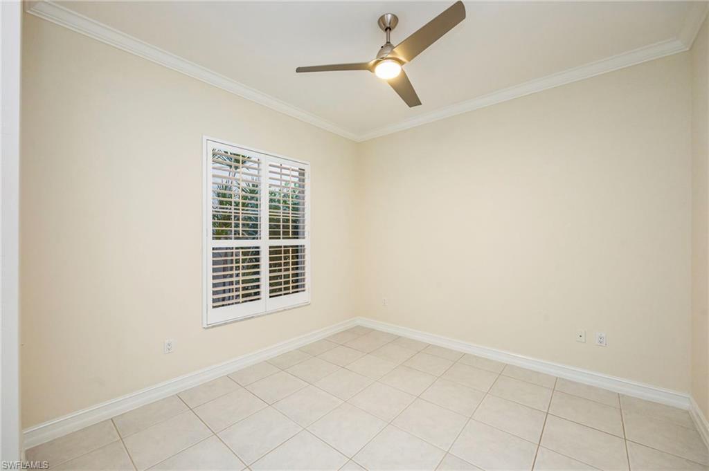 5025 Maxwell Circle, Unit 2 Naples, FL 34105 - Photo 17 of 24 an empty room with windows and fan