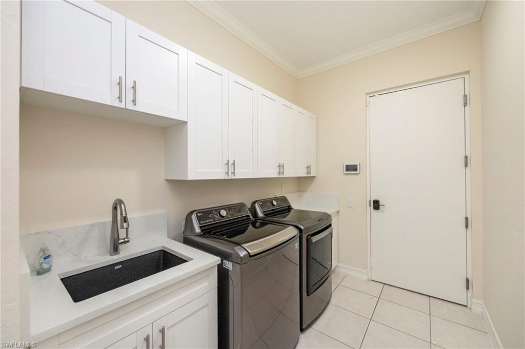 5025 Maxwell Circle, Unit 2 Naples, FL 34105 - Photo 19 of 24 a kitchen with a sink and cabinets