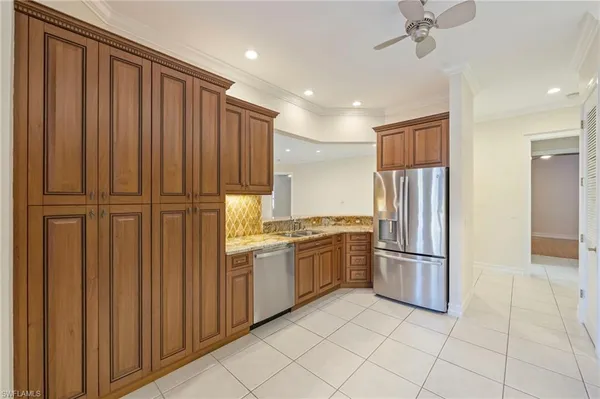 a kitchen with stainless steel appliances granite countertop a refrigerator and a sink