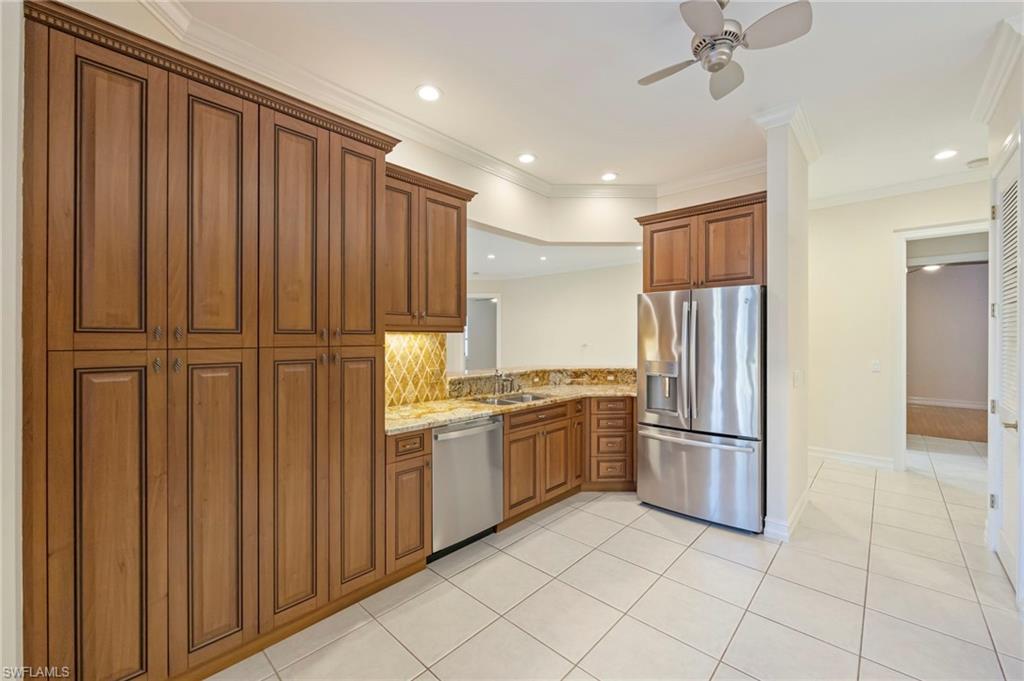 5025 Maxwell Circle, Unit 2 Naples, FL 34105 - Photo 6 of 24 a kitchen with stainless steel appliances granite countertop a refrigerator and a sink