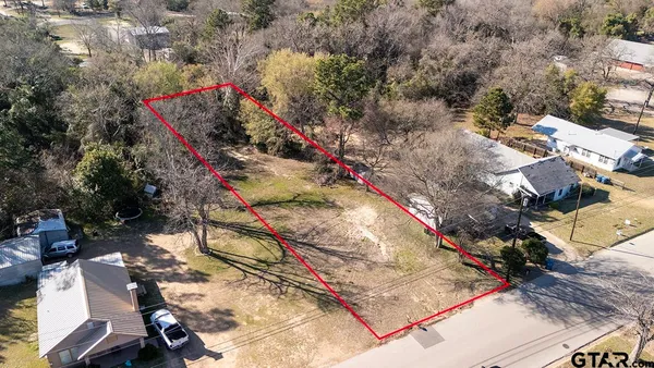 an aerial view of a houses with yard