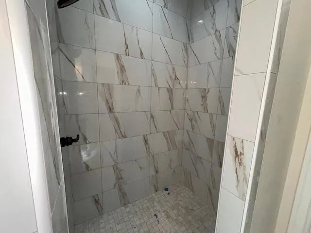 a view of a big room with wooden floor and windows