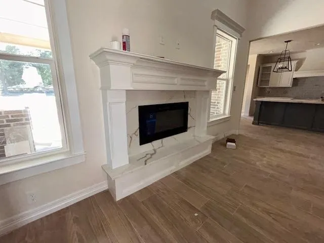 a living room with a fireplace and windows